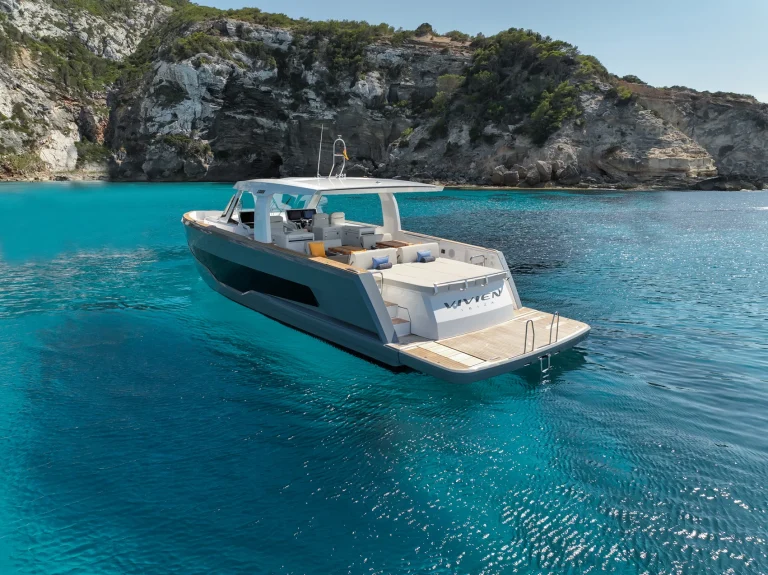 Fjord 53 XL "Vivien" yacht cruising the turquoise waters of Ibiza with spacious sun decks.